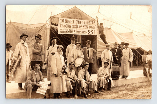 Gagnon Pollock Show circus band and performers posed before canvas tent with theatre sign The Gun Men of New York, 1910s real photo postcard