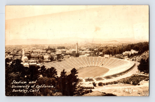 Sepia real photo postcard showing the University of California Football Stadium in Berkeley, California, with panoramic hillside view of the stadium bowl and surrounding campus buildings; posted back with postmark and stamp.