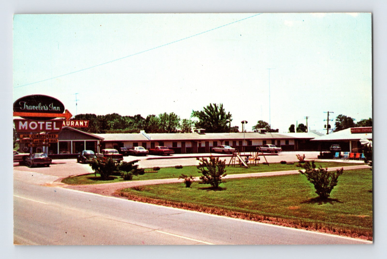 Travelers Inn Motel and Restaurant in South Fulton Tennessee with roadside sign parking lot and 1960s automobiles