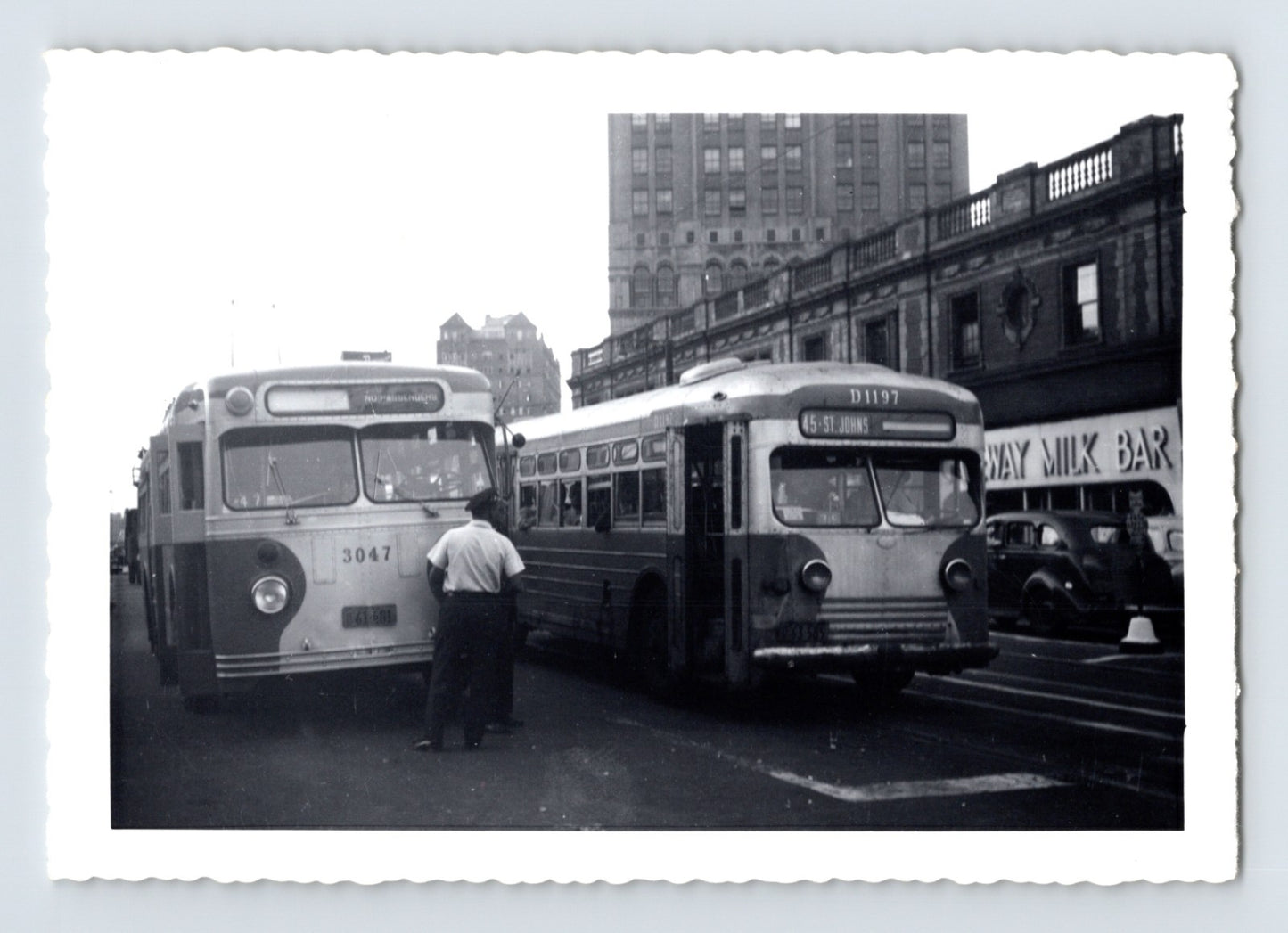 Flushing Avenue Line trackless trolley coaches 3047 and 1197 testing at LIRR station Brooklyn 1940s black and white photograph