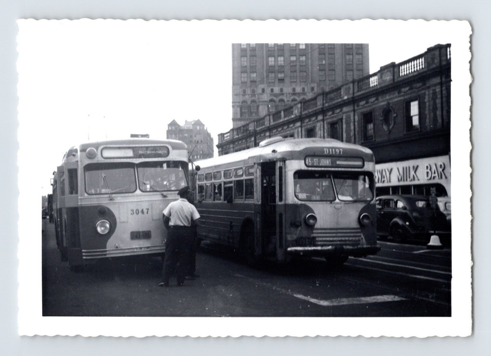 Flushing Avenue Line trackless trolley coaches 3047 and 1197 testing at LIRR station Brooklyn 1940s black and white photograph