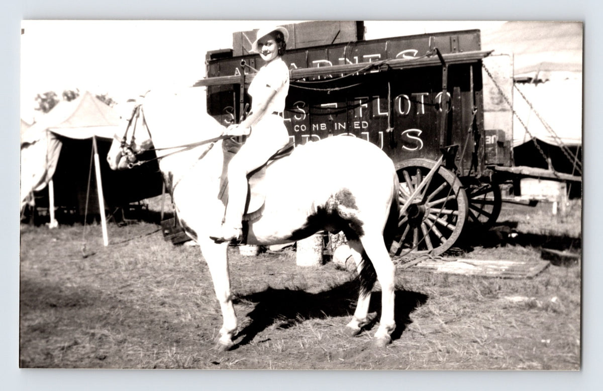 Barnes Sells Floto Circus woman performer riding horse beside circus wagon 1940s circus grounds photograph