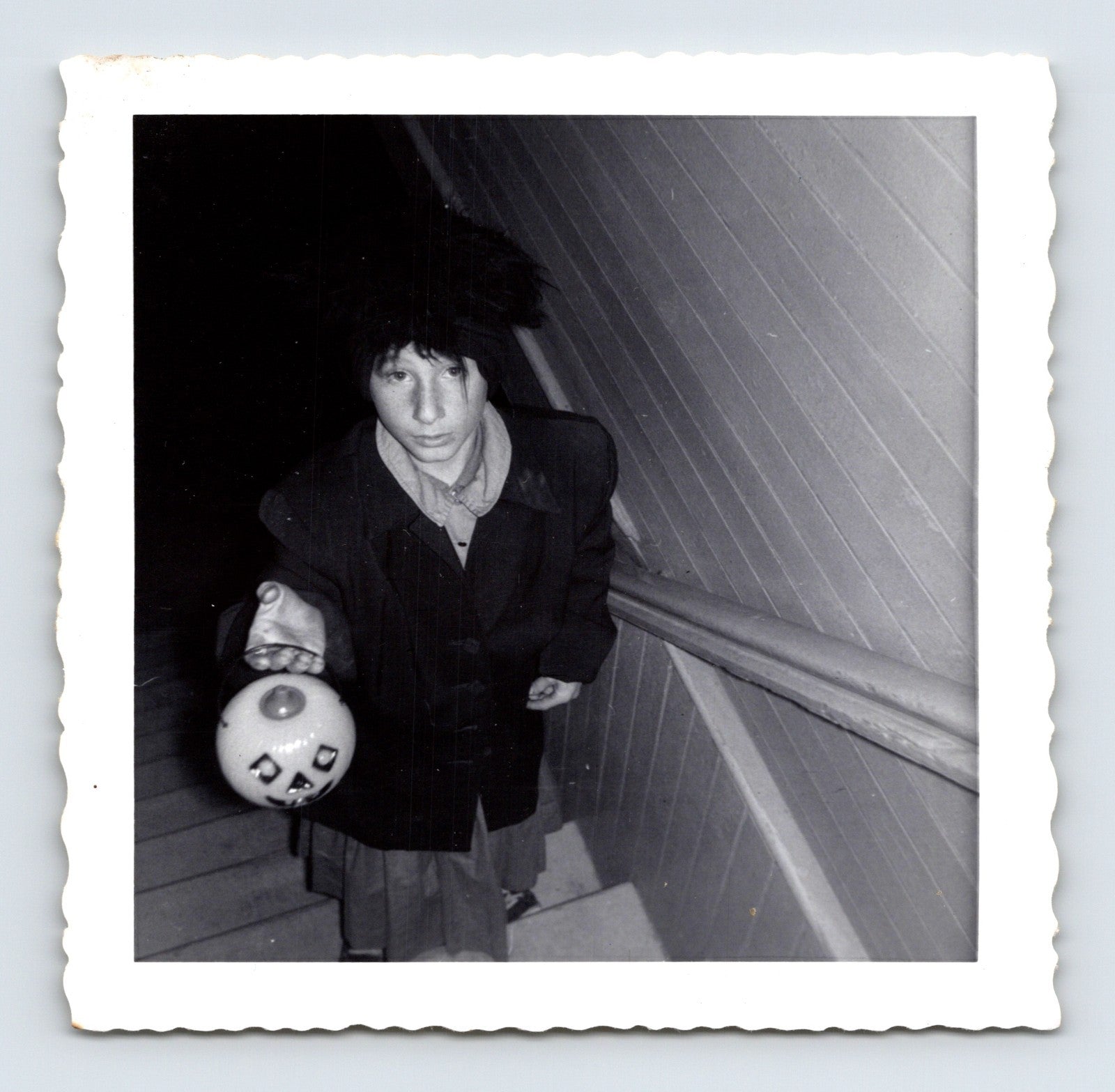 boy holding jack o lantern candy bucket on stairs Halloween 1964 black and white photo
