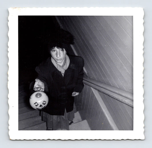 boy holding jack o lantern candy bucket on stairs Halloween 1964 black and white photo