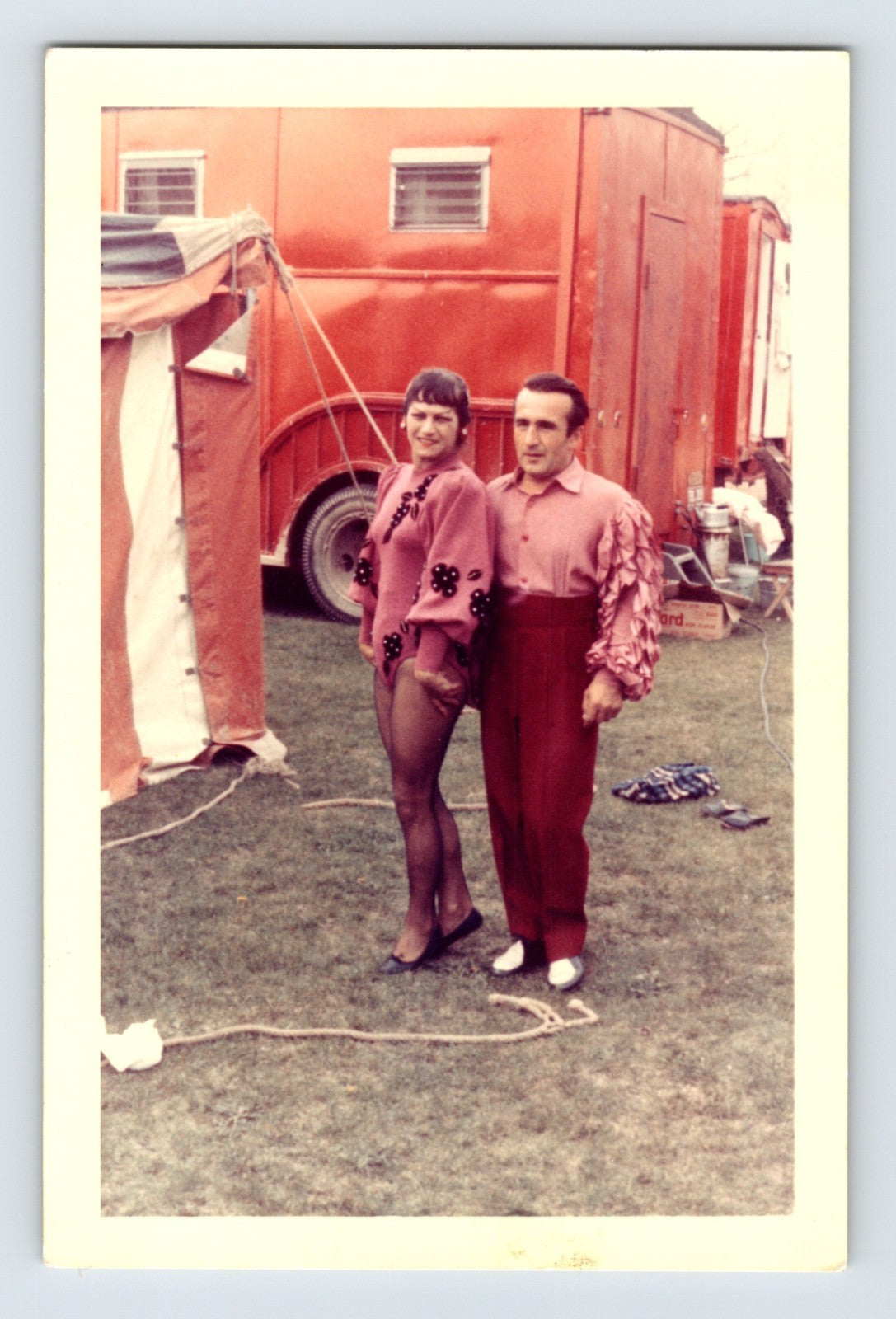 Mills Bros Circus 1960s circus performer couple in costume standing beside red circus truck backstage photograph