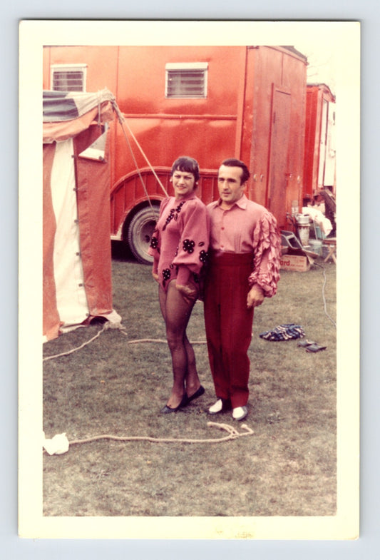 Mills Bros Circus 1960s circus performer couple in costume standing beside red circus truck backstage photograph