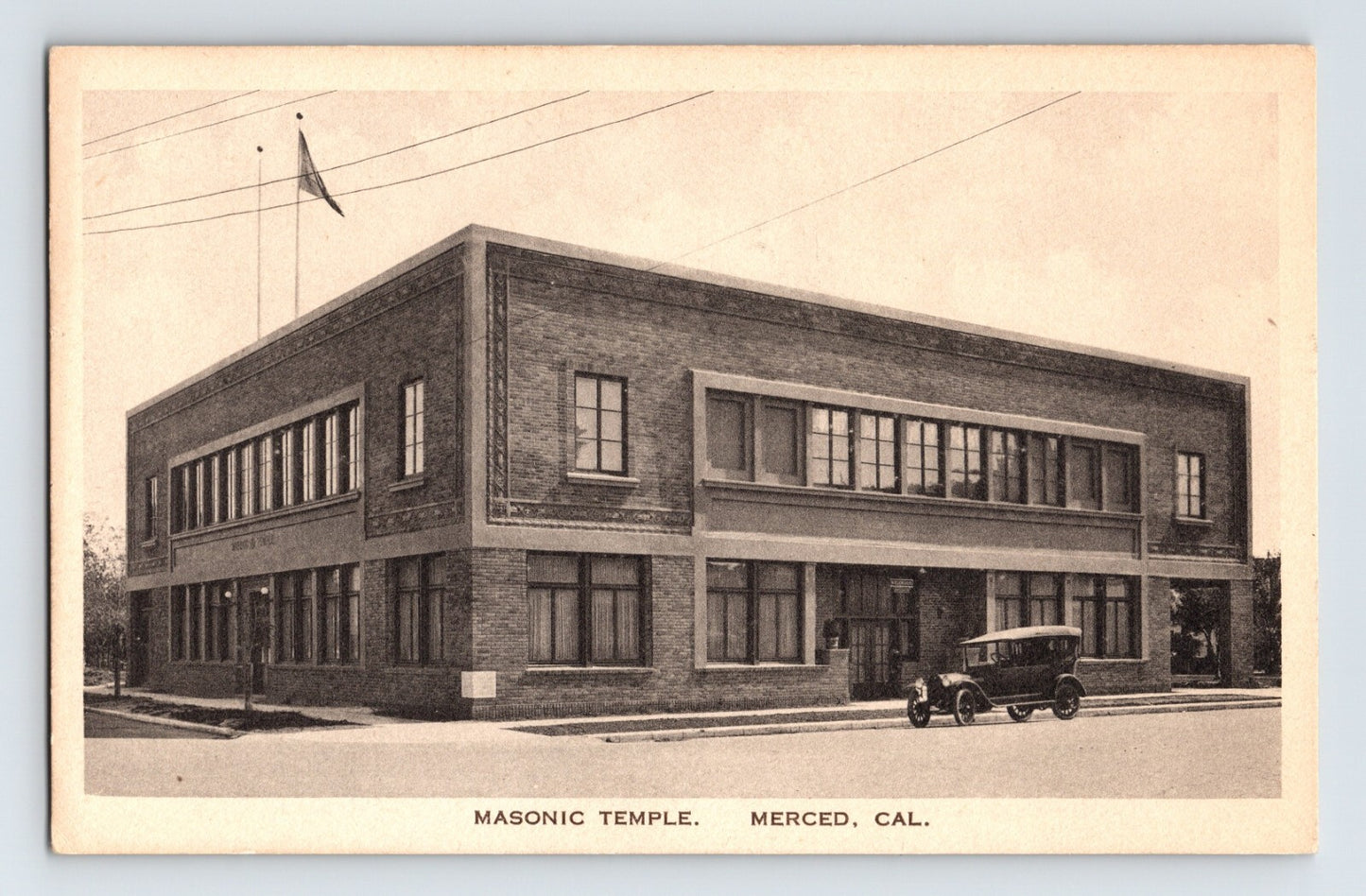 Merced California Masonic Temple brick building with early automobile parked outside, 1920s postcard