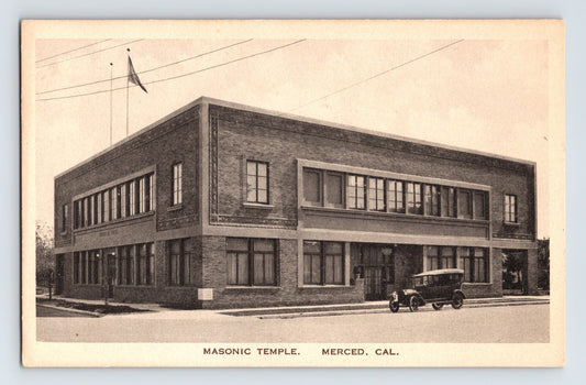Merced California Masonic Temple brick building with early automobile parked outside, 1920s postcard