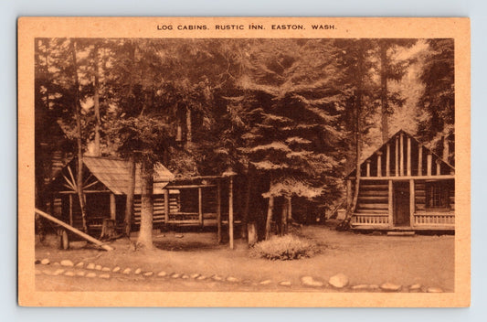 Easton Washington Log Cabins Rustic Inn 1930s postcard showing cluster of timber cabins among tall evergreens