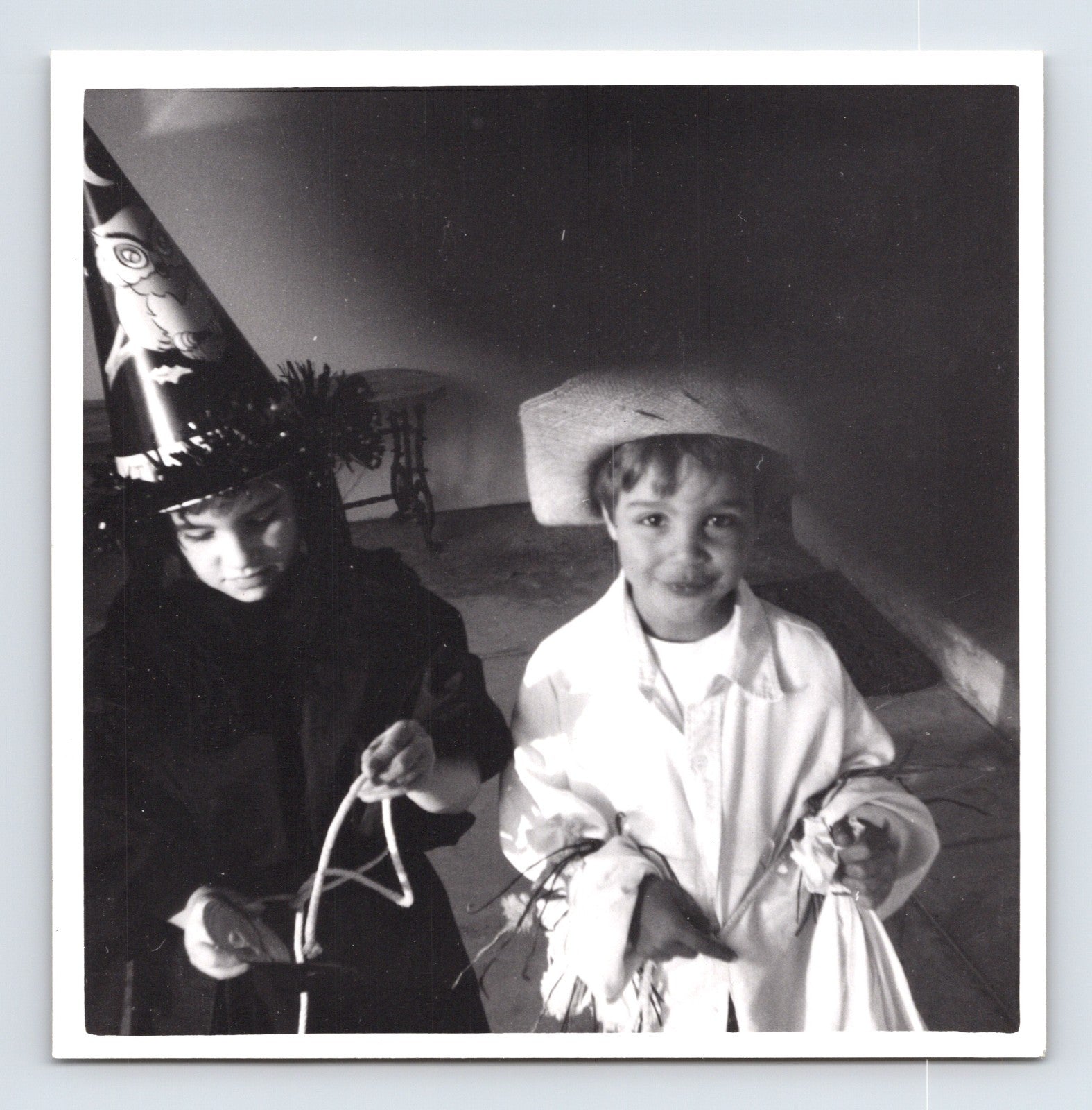 Children Halloween costumes scarecrow and witch holding candy bags 1960s snapshot photo