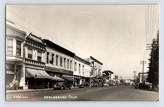 Healdsburg California downtown street view storefronts and parked cars 1940s real photo postcard