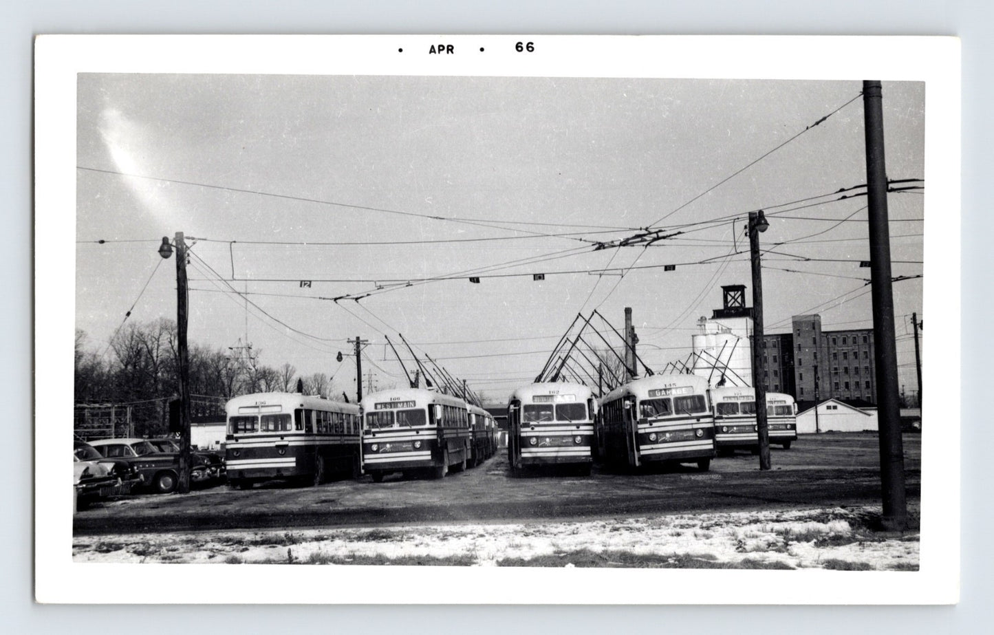 1966 Fort Wayne Transit trolley buses lined up at garage yard with overhead wires April date stamp