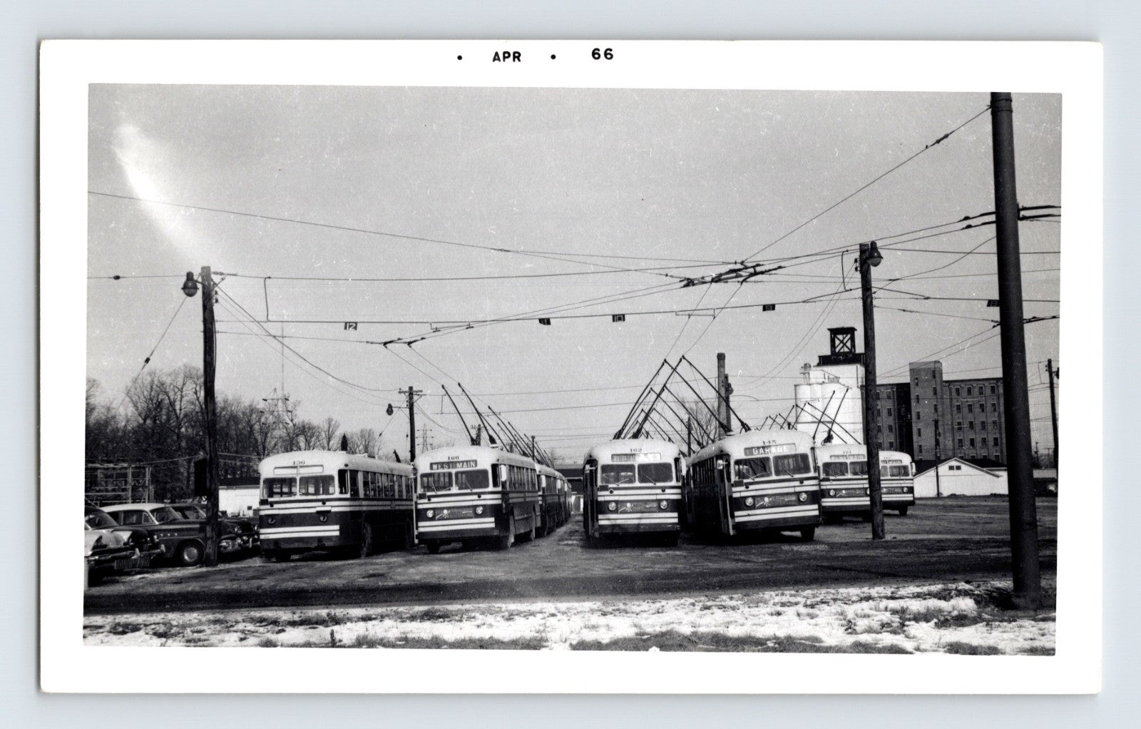 1966 Fort Wayne Transit trolley buses lined up at garage yard with overhead wires April date stamp