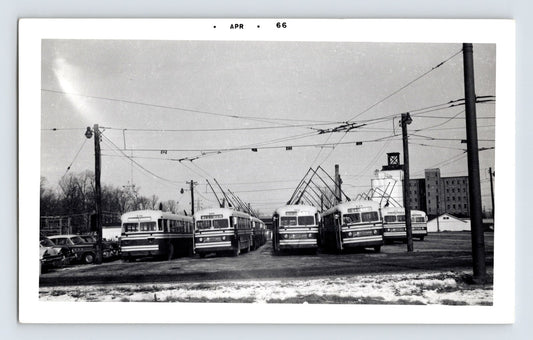 1966 Fort Wayne Transit trolley buses lined up at garage yard with overhead wires April date stamp