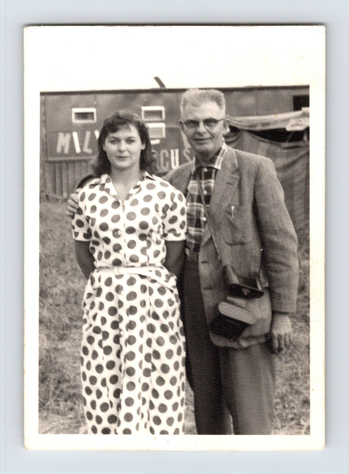 Mills Bros Circus 1940s man and woman posing beside circus wagon on circus grounds photograph