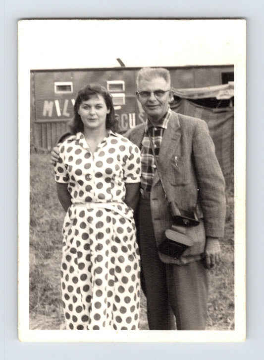 Mills Bros Circus 1940s man and woman posing beside circus wagon on circus grounds photograph