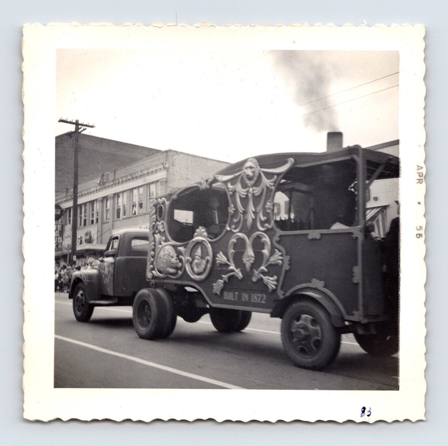 1955 Cole Bros Circus parade wagon snapshot photograph showing an ornate carved calliope-style circus vehicle moving through downtown Decatur GA streets during a parade procession