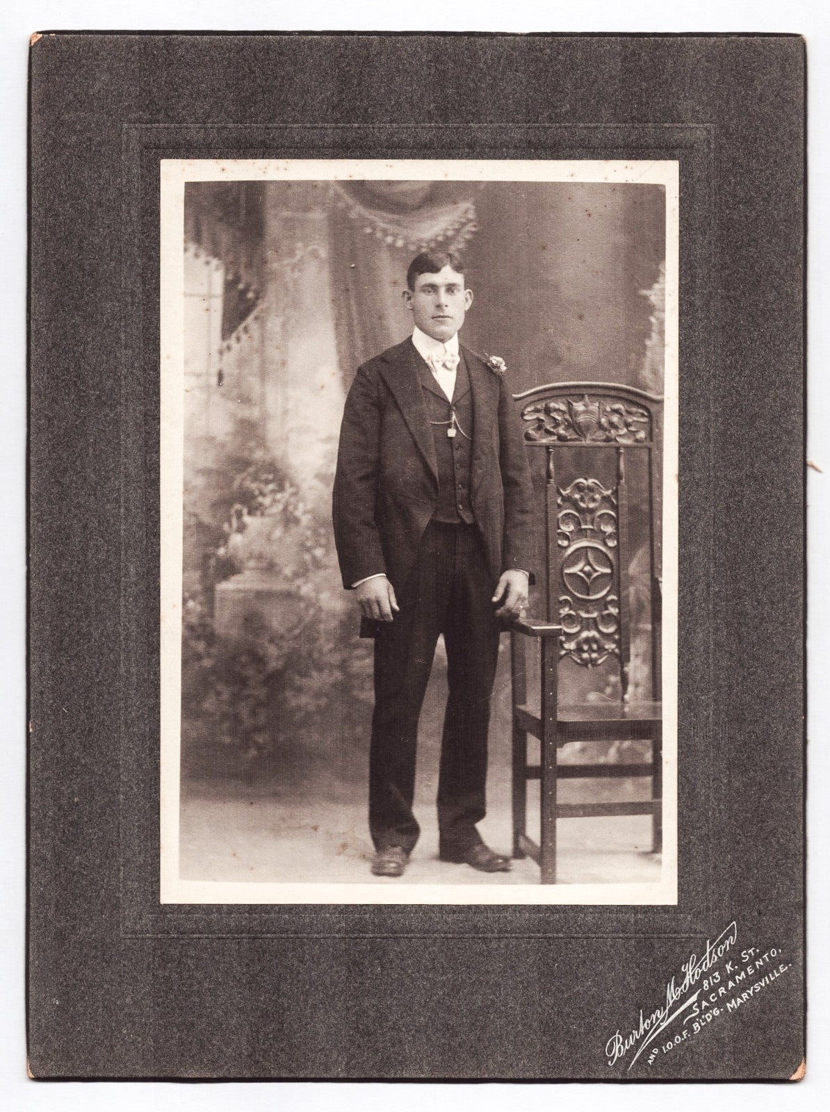 Sacramento California 1910s studio portrait young man suit ornate chair mounted photograph