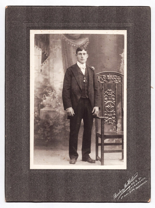 Sacramento California 1910s studio portrait young man suit ornate chair mounted photograph