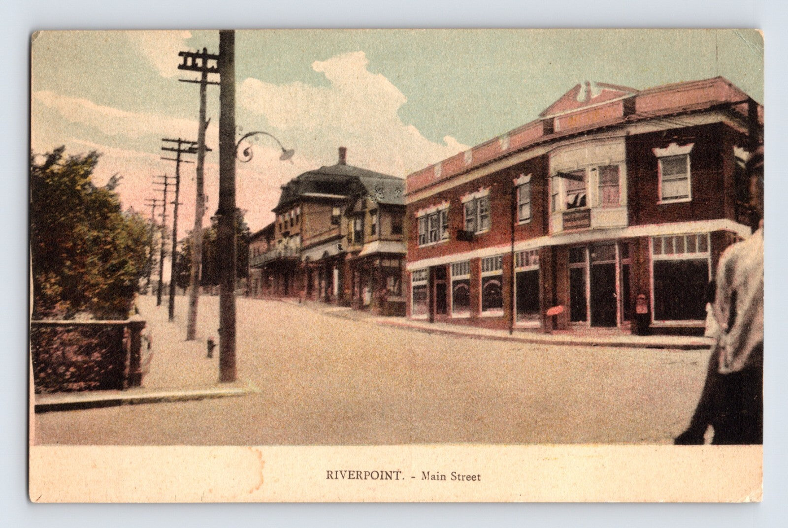Riverpoint Rhode Island Main Street 1910s postcard showing downtown street with brick storefronts utility poles and early commercial buildings1