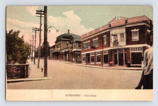 Riverpoint Rhode Island Main Street 1910s postcard showing downtown street with brick storefronts utility poles and early commercial buildings1