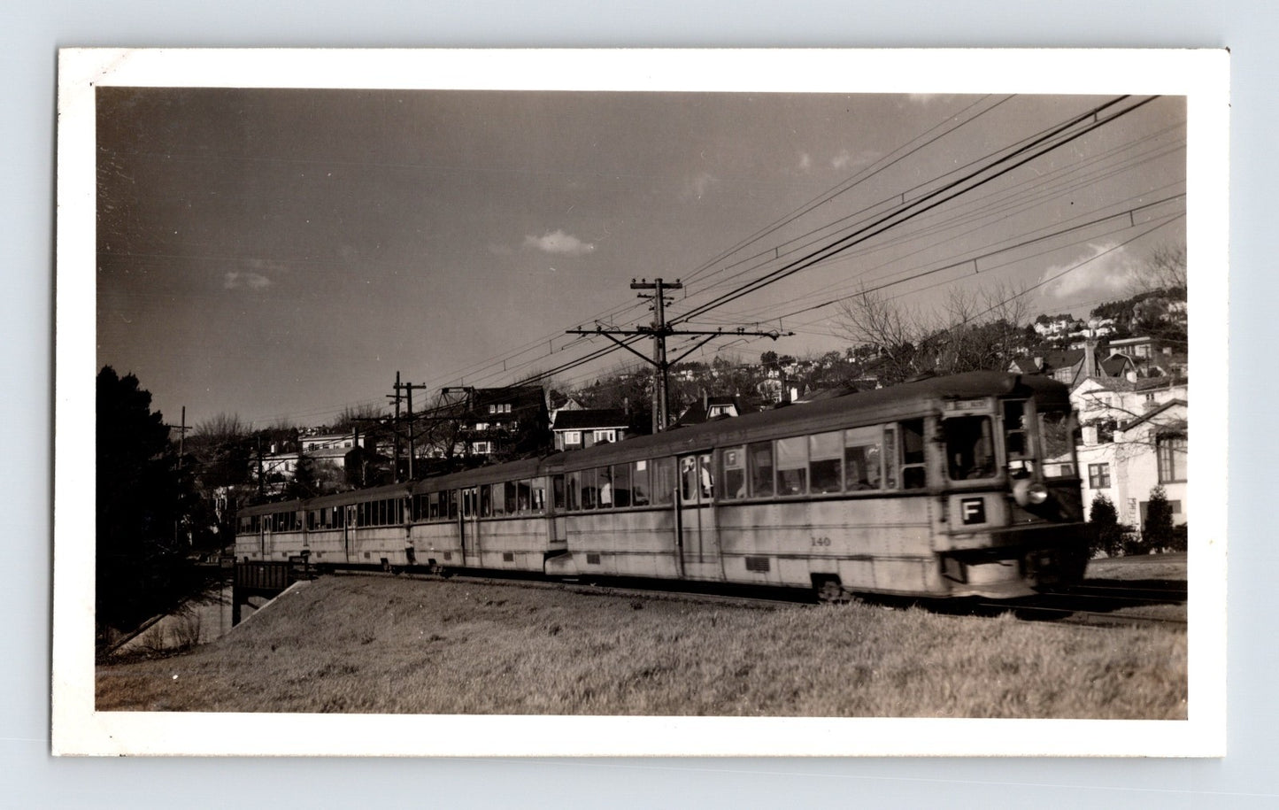 Key System F Line electric train traveling through residential hillside area in Berkeley, California, 1946 photograph.