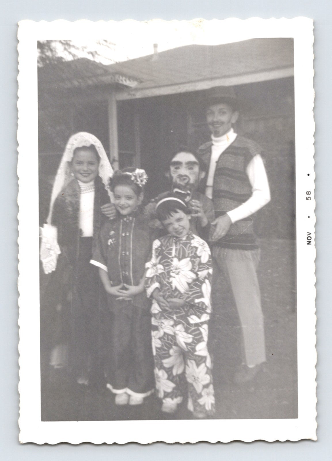 Halloween photo children costumes group porch 1950s snapshot kids dressed up masks makeup outdoor scene 5 x 3.5