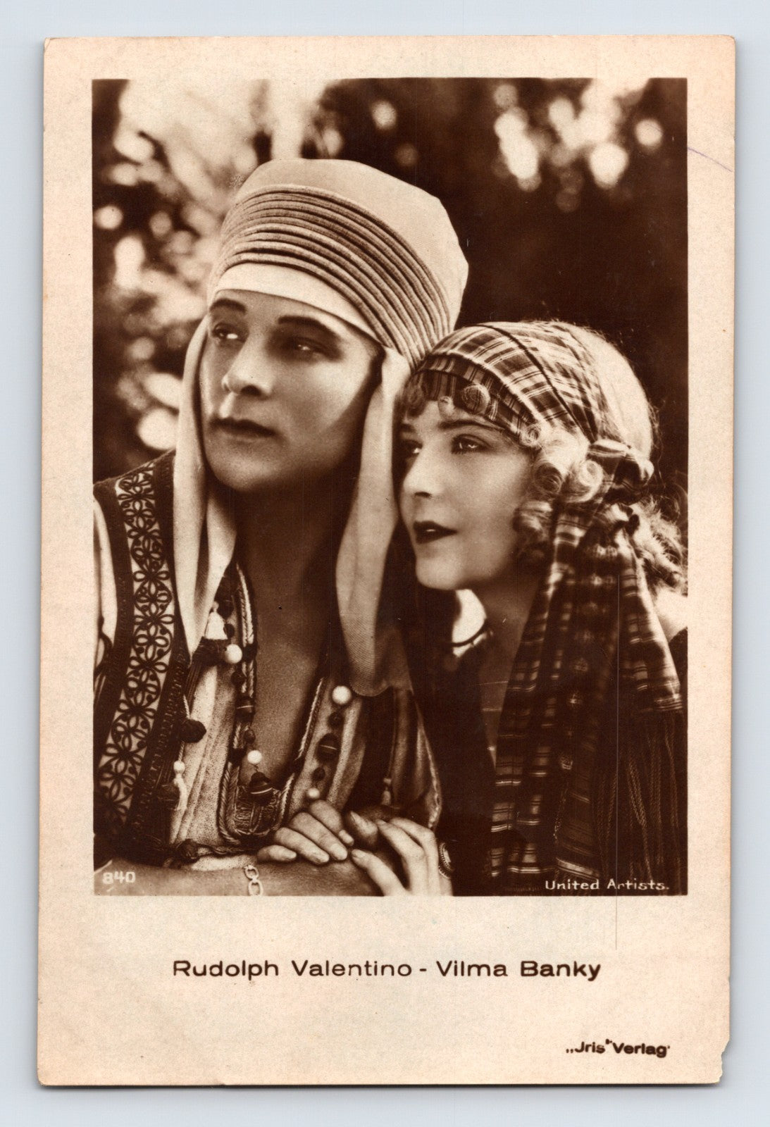 Real photo postcard of Rudolph Valentino and Vilma Banky in period costume, sepia studio portrait issued by United Artists
