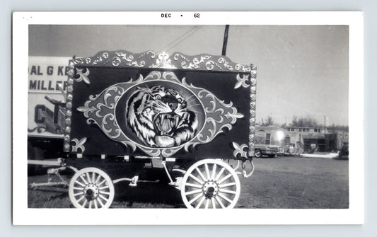 Black and white photograph of Kelly Miller Circus wagon with painted tiger tableau and decorative scrollwork panels, dated December 1962