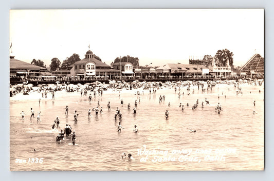 Santa Cruz California beach and boardwalk RPPC postcard with swimmers amusement rides and crowded shoreline scene