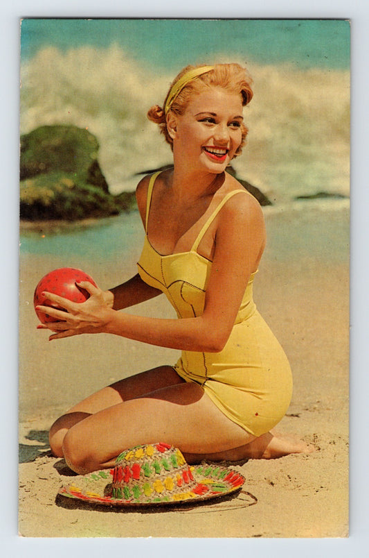 blonde pin up woman yellow swimsuit beach ball ocean 1950s chrome postcard