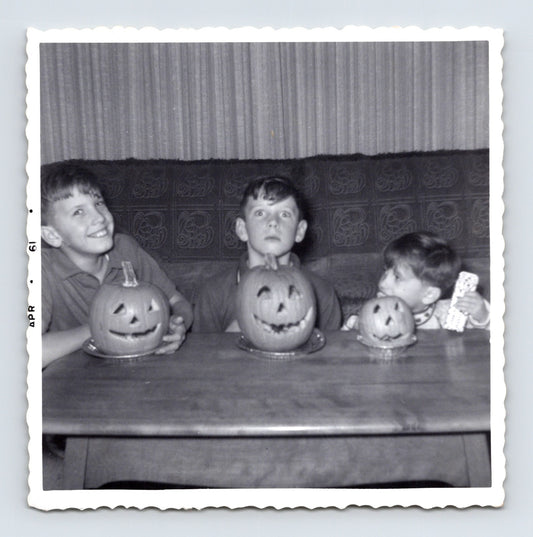 1961 children carved pumpkins jack o lanterns table indoor Halloween snapshot three kids photo