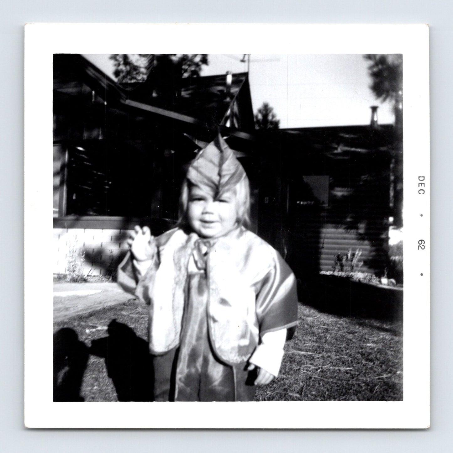 Vintage Halloween toddler costume snapshot 1962 outdoor yard black white photo child waving