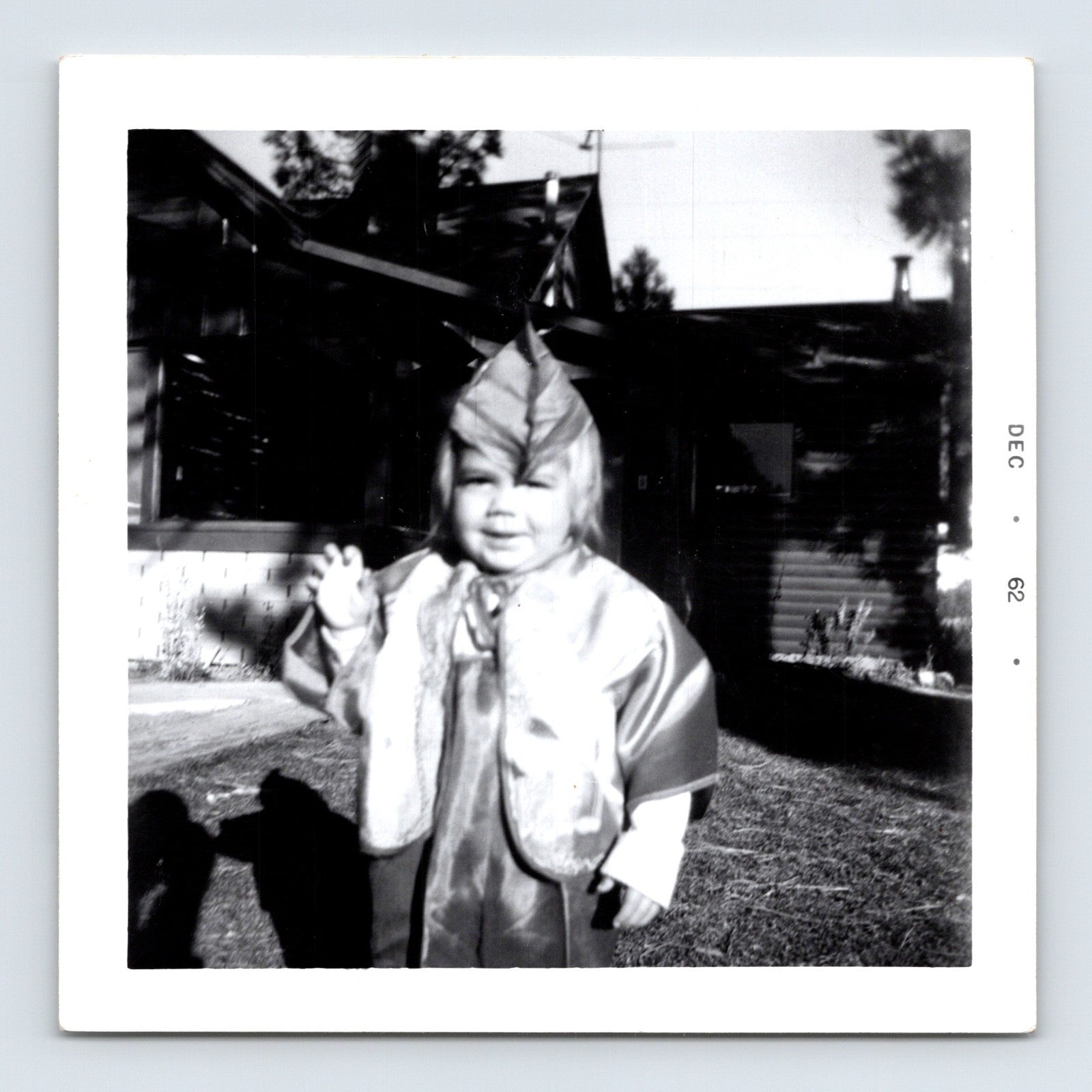 Vintage Halloween toddler costume snapshot 1962 outdoor yard black white photo child waving
