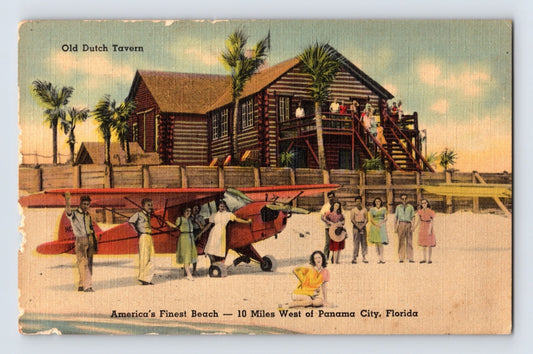 Panama City Florida Old Dutch Tavern beach scene with red airplane and elevated log tavern building 1940s linen postcard front view