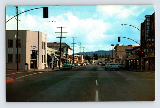 Willits California downtown 1960s postcard showing main street with Al’s Liquor hotel sign traffic lights storefronts and parked cars