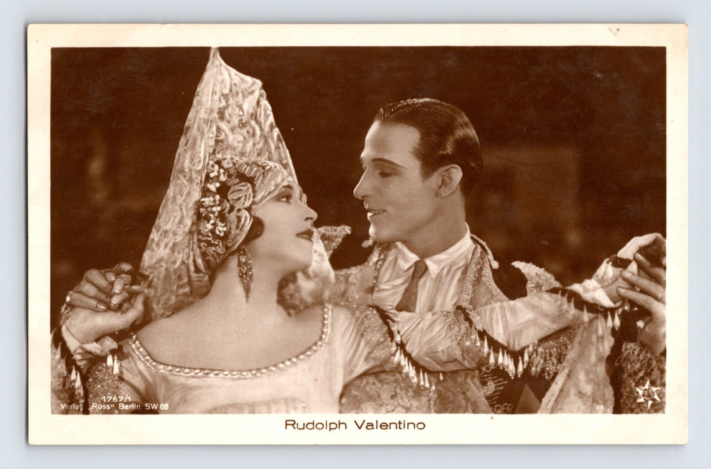 Rudolph Valentino costumed scene romantic pose Ross Verlag 1930s RPPC postcard