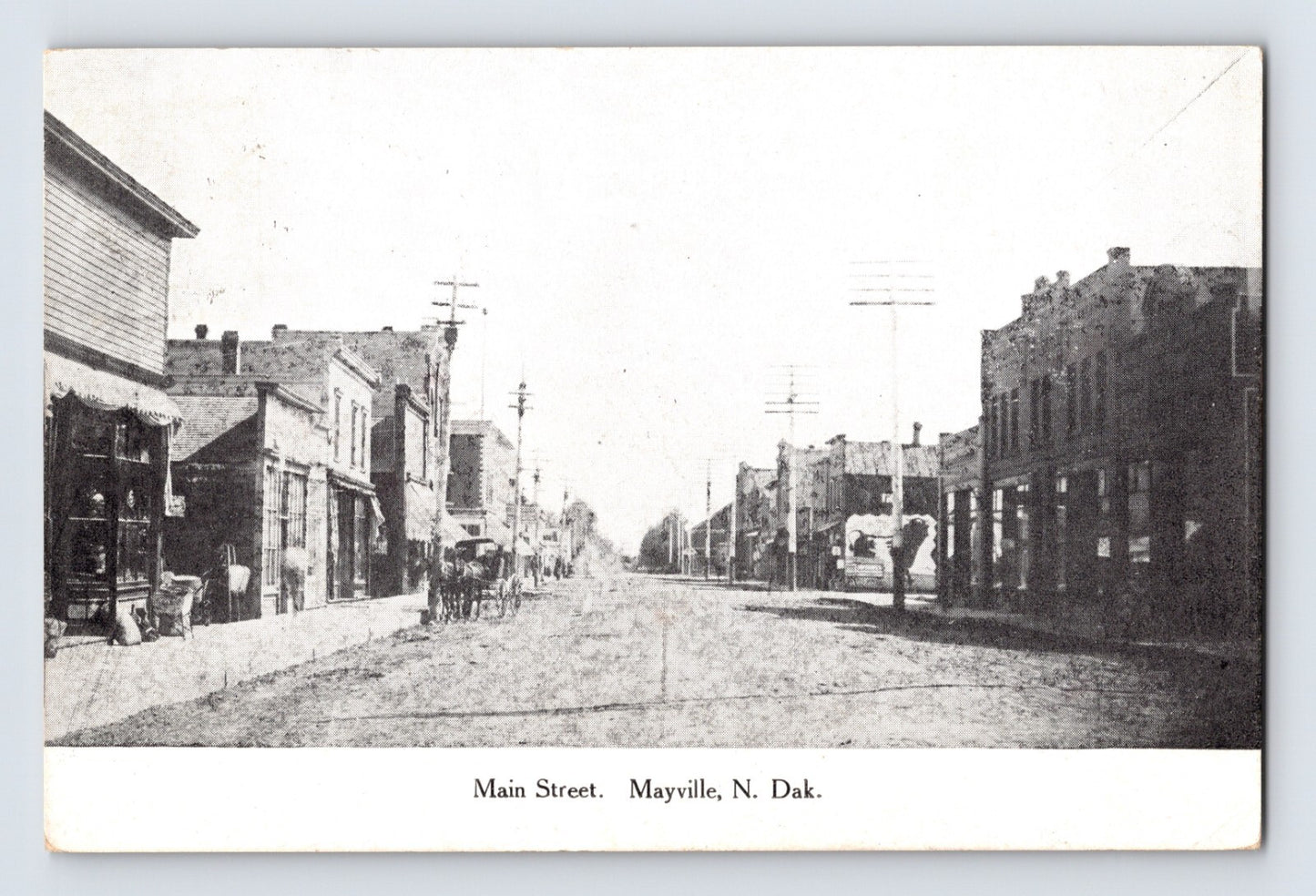 Mayville North Dakota Main Street with storefront buildings, horse-drawn carriage and unpaved road stretching through downtown