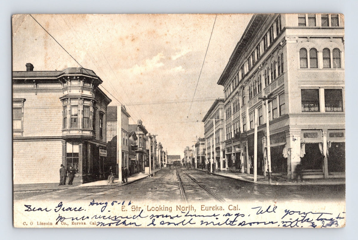 Eureka California E Street Downtown 1906 Postcard Posted Undivided Back featuring streetcar tracks commercial blocks and early storefront signage