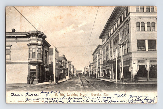 Eureka California E Street Downtown 1906 Postcard Posted Undivided Back featuring streetcar tracks commercial blocks and early storefront signage