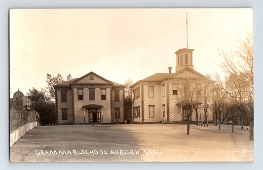 Real photo postcard of Auburn California Grammar School with central cupola and schoolyard 1910s