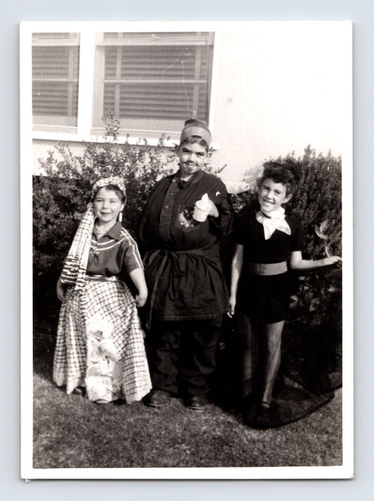 Children Halloween costumes outdoor yard girl dress boy mustache costume mid century photo