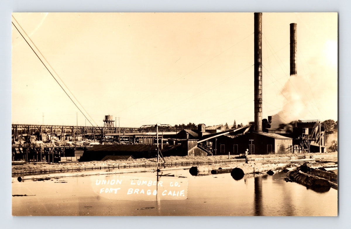 Vintage real photo postcard showing Union Lumber Company mill complex with smokestacks and log pond at Mendocino California waterfront