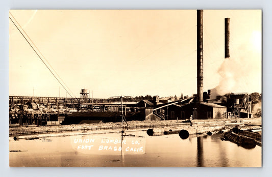Vintage real photo postcard showing Union Lumber Company mill complex with smokestacks and log pond at Mendocino California waterfront