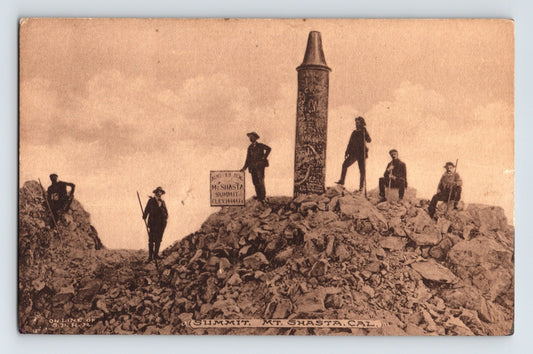 Mount Shasta California summit monument postcard 1910s climbers posed on rocky peak cairn
