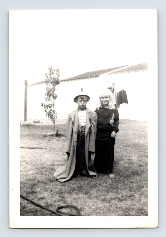 Halloween children costumes oversized coat dress backyard snapshot 1960s black and white photo