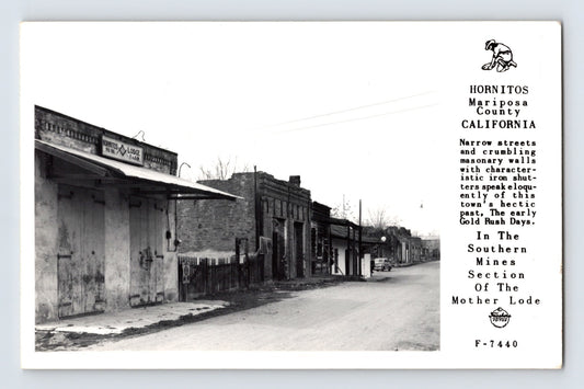 Hornitos California 1940s RPPC postcard showing weathered Gold Rush-era brick buildings and narrow street in Mariposa County mining district.