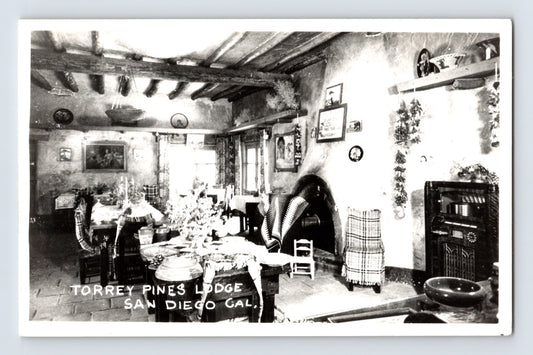 San Diego California Torrey Pines Lodge interior 1940s RPPC postcard showing rustic fireplace room with period furnishings and radio.