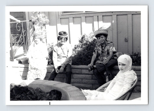 Children Halloween costumes seated patio fire pit mummy guitar hats mid century snapshot