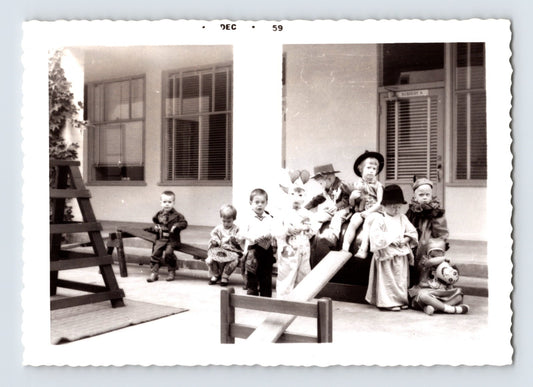 Children Halloween costumes nursery playground seesaw group snapshot December 1959